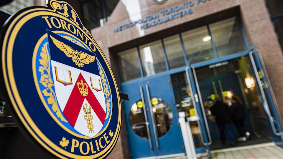 The Toronto Police crest close-up in front of the entrance to their headquarters.